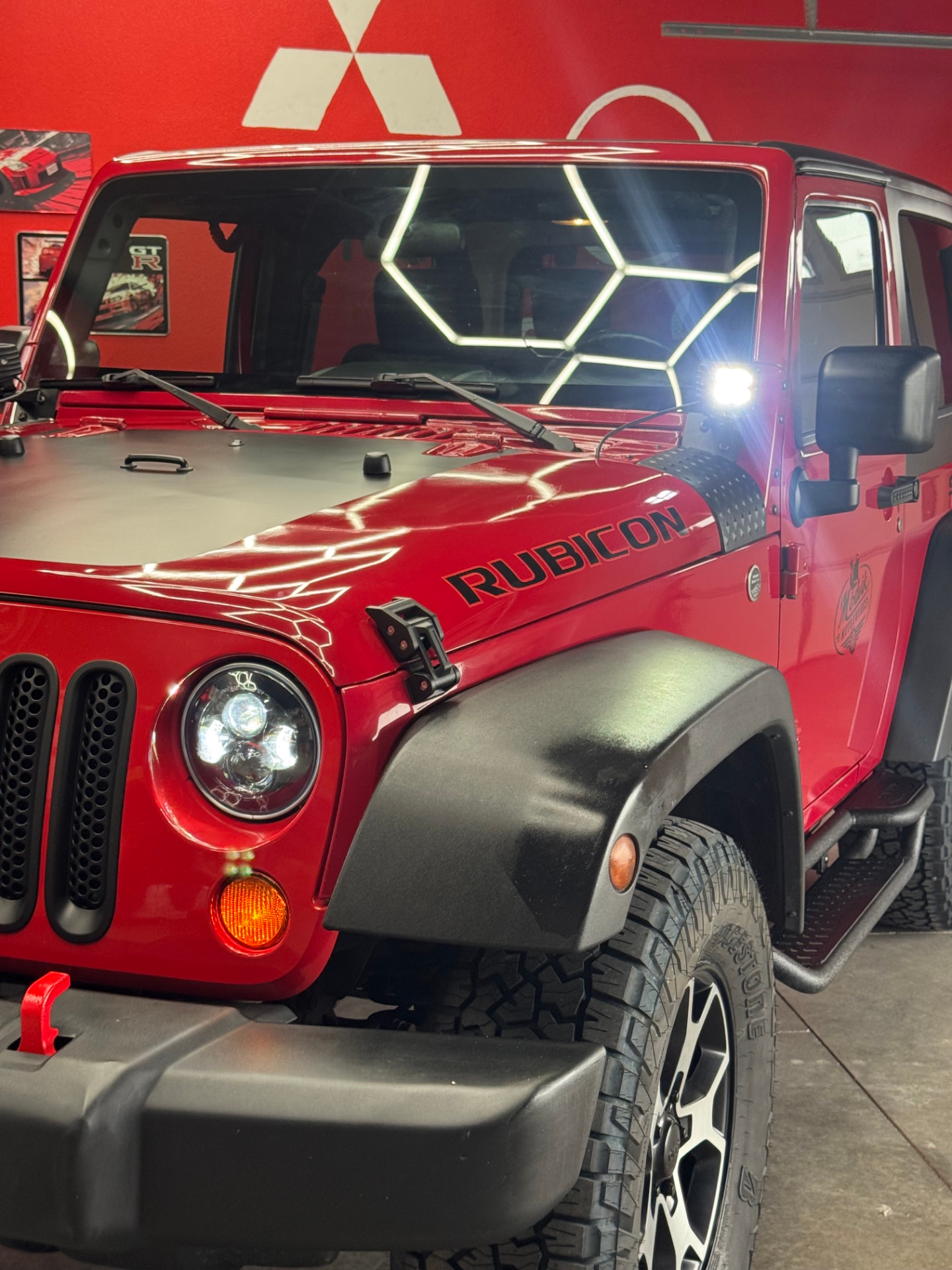 Close-up of Skadi's LED headlight, grille inserts, and metal hood latch