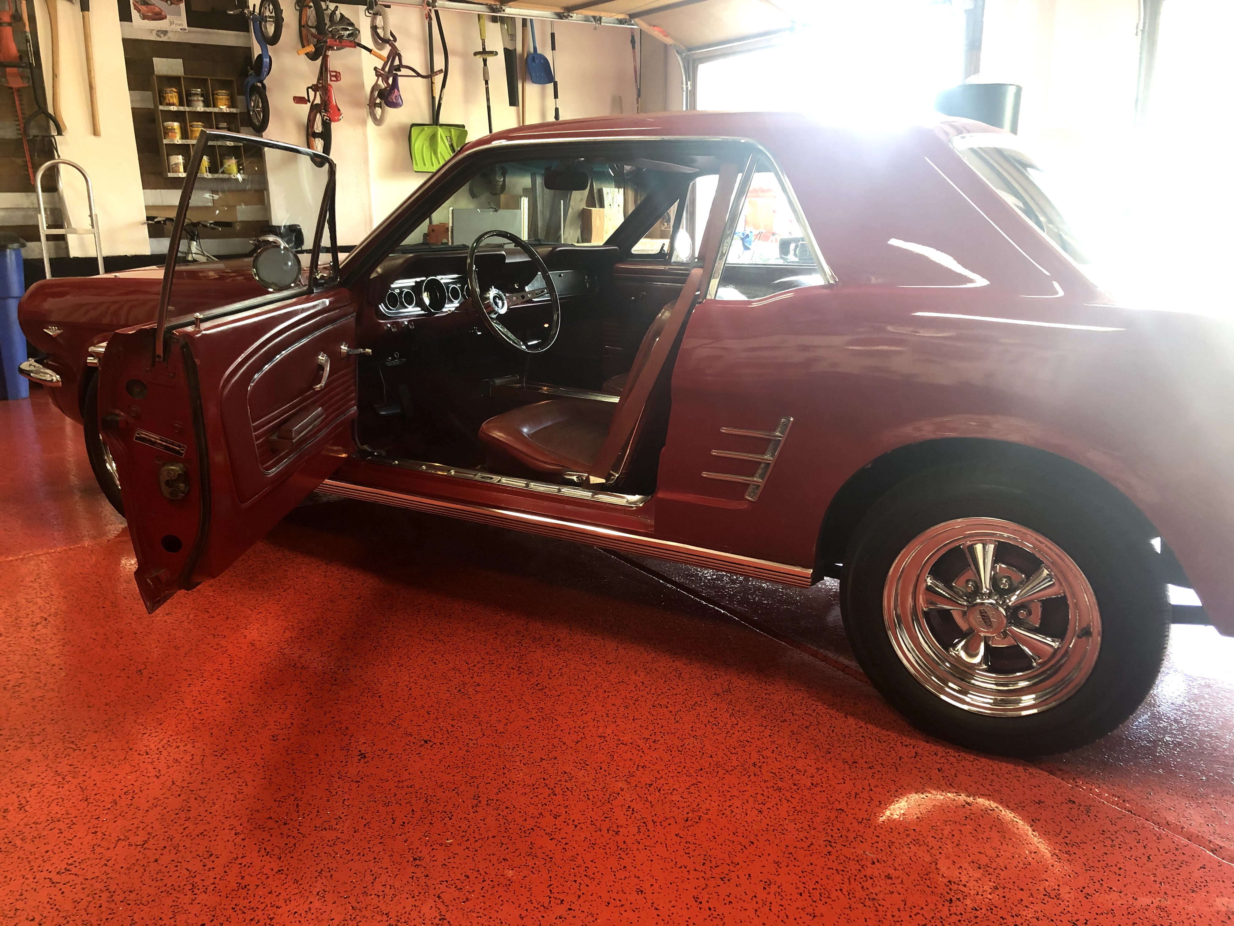 1966 Mustang in the garage with driver door open