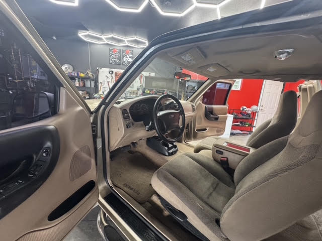 Interior view from driver door showing cleaned seats and dash