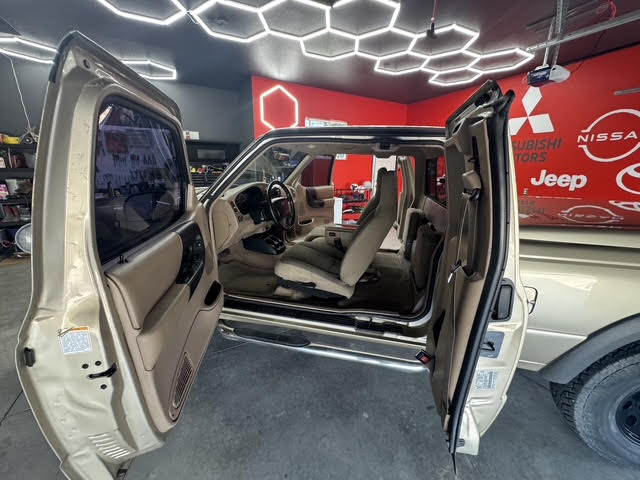 Both doors open showing full cab and cleaned interior
