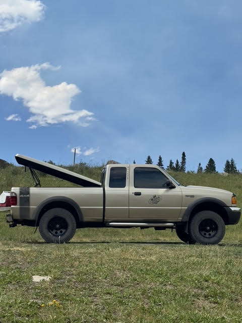 Ragnar side profile in a mountain meadow with tonneau open