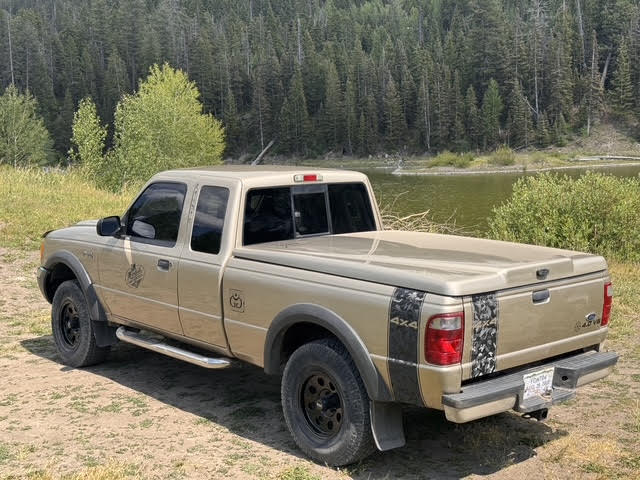 Ragnar rear quarter parked by an alpine lake