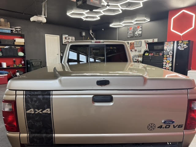 Rear view with color-matched hard tonneau cover and 4x4 camo decal