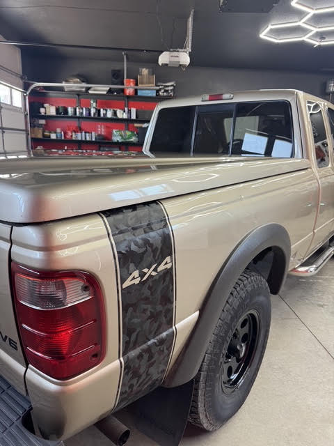 Rear quarter with custom 4x4 black camo vinyl banner