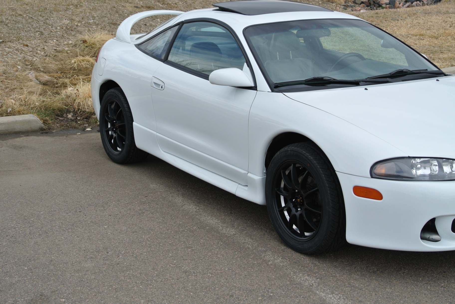 Side profile of white Eclipse GSX with black wheels